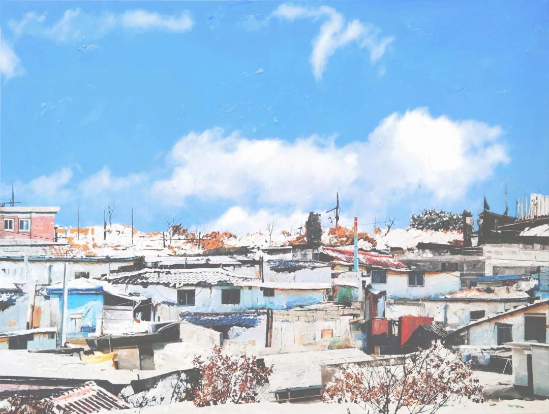김규학, 〈바람과 빛-62〉, 캔버스에 유화, 80x61cm — 파란 하늘에 흰 구름이 크게 떠 있고 그 아래로 낮은 지붕들이 빽빽하게 이어지며 앞쪽에 붉은 잎이 달린 마른 관목이 서 있다